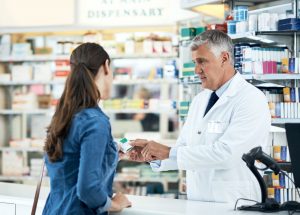 male-pharmacist-talking-with-a-patient-about-a-medication-in-a-community-pharmacy