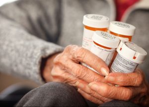 hands-of-an-elderly-woman-holding-prescription-medication-bottles