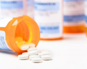 prescription-medication-bottles-and-white-tablets