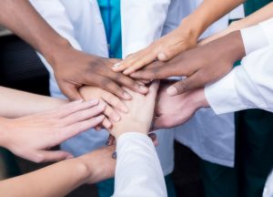 group-of-unified-healthcare-professionals-hands-together-in-a-circle